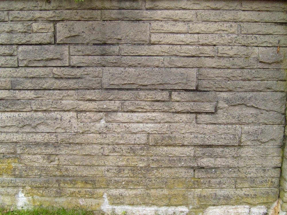 An old grey brick wall, coarse texture in flat light